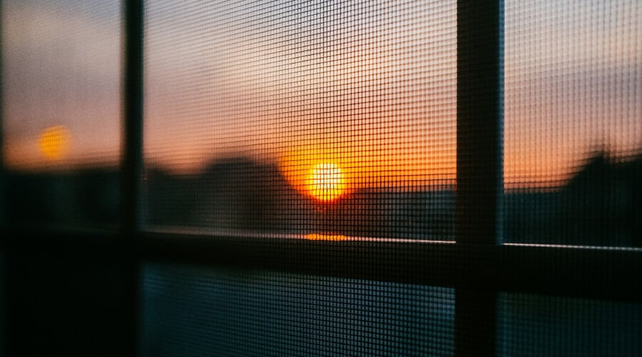 A setting sun viewed through a solar screen